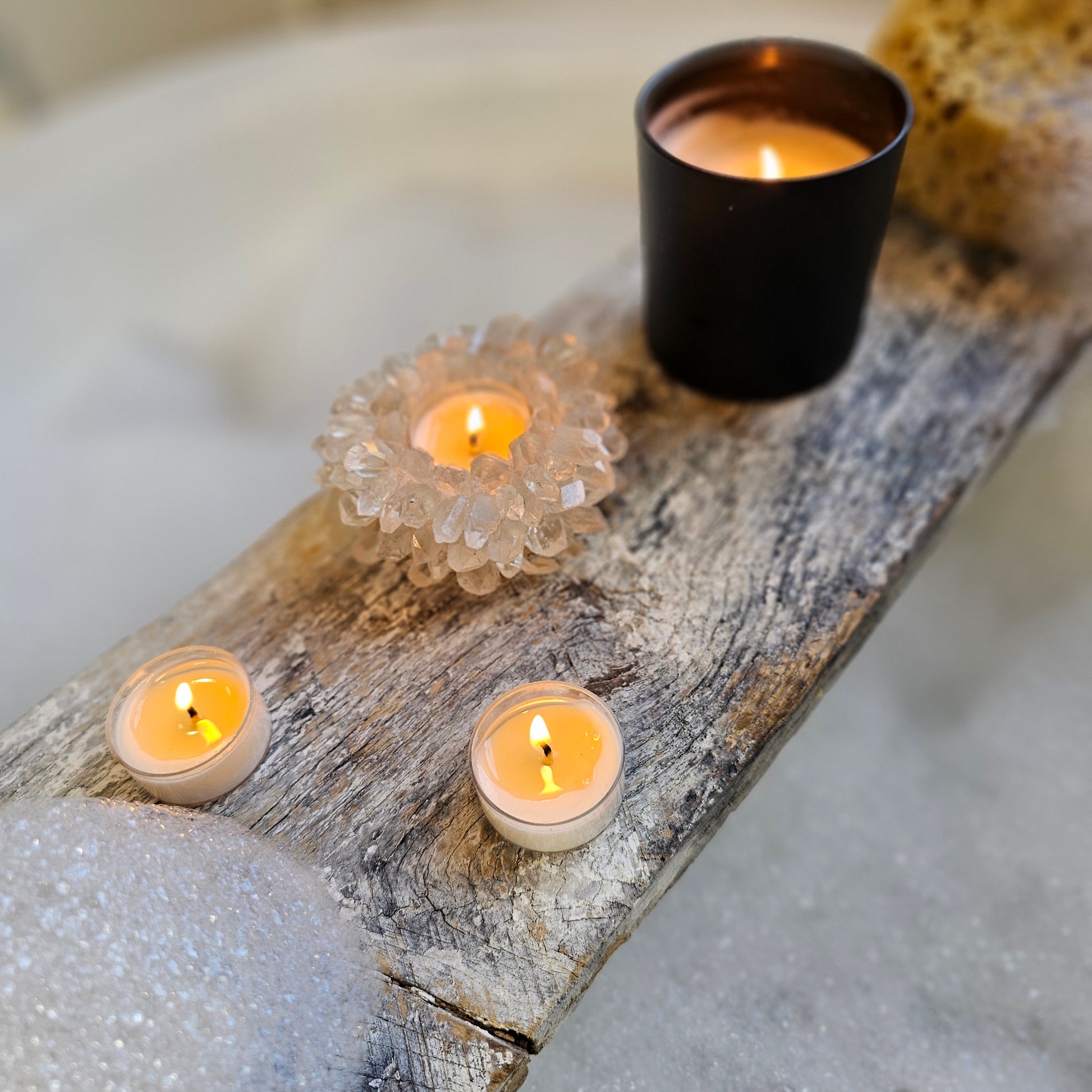 Decorative setup with candles in holders on a wooden surface